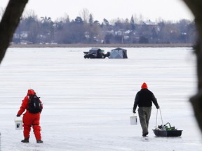 Fishermen walk on to the ice on the Bay of Quinte in Belleville, Ont. on Feb. 23, 2016.