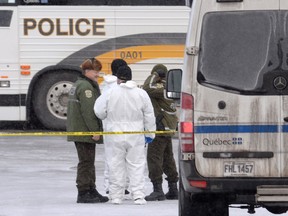 Police attend the scene of a shooting at a Quebec City mosque on Monday. Initially, they said there were two suspects but later corrected the report.