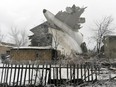 The tail of a crashed Turkish Boeing 747 cargo plane lies at a residential area outside Bishkek, Kyrgyzstan Monday, Jan. 16, 2017