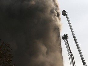 Iranian firefighters work to extinguish fire of the Plasco building in central Tehran, Iran, Thursday, Jan. 19,. The building collapsed on Thursday as scores of firefighters battled the blaze, killing 30 of them.