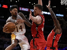 Los Angeles Lakers forward Brandon Ingram, left, is stymied by Toronto Raptors Jakob Poeltl and Lucas Nogueira during the second half the NBA game in Los Angeles on Sunday, Jan. 1, 2017. The Toronto Raptors won 123-114.