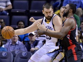Marc Gasol of the Grizzlies controls the ball against Toronto Raptors forward Patrick Patterson in the first half of their game on Wednesday night in Memphis, Tenn.