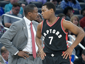 In this Dec. 18, 2016 file photo, Toronto Raptors head coach Dwane Casey (left) and Kyle Lowry speak during a game against the Orlando Magic.