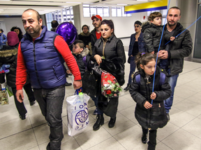 A family of newly-arrived Syrian refugees arrive at the Calgary International Airport in December 2015.