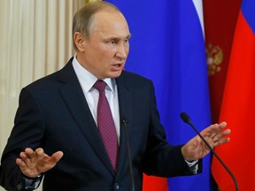 Russian President Vladimir Putin speaks at a joint news conference with Moldovan President Igor Dodon in the Kremlin in Moscow, Russia, Tuesday, Jan. 17, 2017.  President Vladimir Putin on Tuesday accused the outgoing U.S. administration of trying to undermine President-elect Donald Trump by spreading fake allegations.