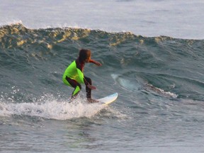 Surfer Eden Hasson, 10, didn't see the shark until he got to shore and saw this photo that his father had taken.