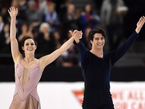 Tessa Virtue and Scott Moir celebrate as they finish the senior ice dance free dance to take gold at the National Skating Championships in Ottawa on Saturday, Jan. 21, 2017.