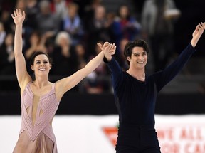 Tessa Virtue and Scott Moir celebrate as they finish the senior ice dance free dance to take gold at the National Skating Championships in Ottawa on Saturday, Jan. 21, 2017.