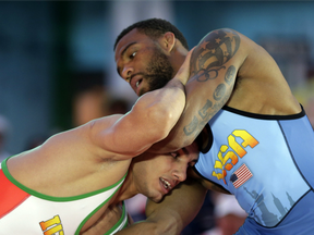 In this May 19, 2016 file photo, Iran's Pehman Yarahmadi, bottom, grapples with Jordan Burroughs of the United States in a 163-pound match during the Beat the Streets wrestling exhibition in New York.