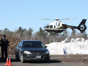 An OPP helicopter lands at Henvey Inlet First Nation on Wednesday March 18, 2015.