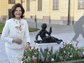 In this 2015 photo, Queen Silvia unveils a sculpture by Adrien De Vries, "Young Hercules with Snake", at the Drottningholm Royal Palace near Stockholm, Sweden. Queen Silvia says one of the Swedish royal family's palaces, Drottningholm, is haunted but the phantoms are "pretty friendly."