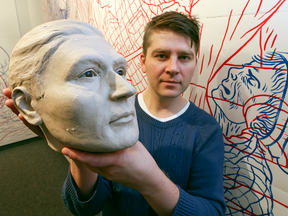 Aartist Michael Markowsky holds up a clay facial reconstruction — that may or may not be based on Tom Thomson's skull — made by forensic artist Louise Solecki-Wier.