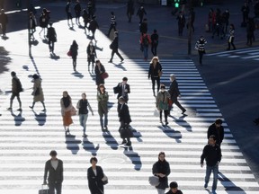 People cross the road near the Shibuya Station in Tokyo, Japan. The large intersection is said to be the busiest in the world.