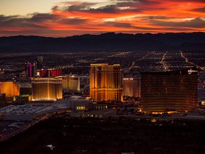 The Venetian, left,, The Palazzo, centre, and Wynn Resort Holdings hotels stand on The Strip in this aerial photograph taken at dusk above Las Vegas on Aug. 5, 2015.