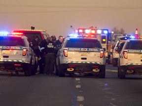 Emergency personnel gather at the scene on Thursday where an Arizona trooper was shot.