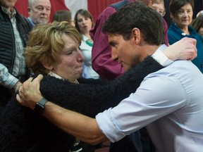Prime Minister Justin Trudeau speaks with an emotional Kathy Katula, from Buckhorn, Ont. following a news conference in Peterborough, Ont. Friday January 13, 2017.