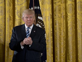 U.S. President Donald Trump listens during a swearing in ceremony of White House senior staff in the East Room of the White House in Washington, D.C., U.S., on Sunday, Jan. 22.