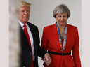 British Prime Minister Theresa May and U.S. President Donald Trump hold hands as they walk along The Colonnade at The White House on Jan. 27, 2017.