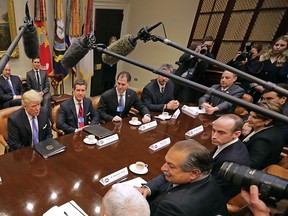 U.S. President Donald Trump leads a meeting with invited business leaders and members of his staff in the Roosevelt Room at the White House January 23, 2017 in Washington, DC