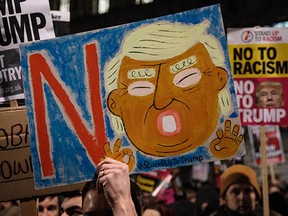 Demonstrators hold up placards during a protest outside Downing Street against U.S. President Donald Trump's ban on travel from seven Muslim countries on Monday in London.