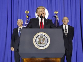 President Donald Trump, accompanied by Vice President Mike Pence, left, and Homeland Security Secretary John F. Kelly, pauses while speaking at the Homeland Security Department in Washington, Wednesday, Jan. 25, 2017.