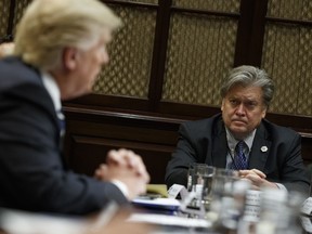 White House Chief Strategist Steve Bannon listens at right as President Donald Trump speaks during a meeting on cyber security in the Roosevelt Room of the White House in Washington, Tuesday, Jan. 31.