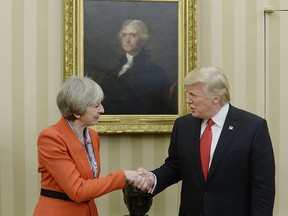 U.S. President Donald Trump, right, shakes hands with Theresa May, U.K. prime minister, in the Oval Office of the White House in Washington, D.C., U.S., on Friday, Jan. 27, 2017. The British prime minister is planning to pitch a free-trade deal to the new U.S. leader just as the reality of a new era of protection for American workers sinks in.