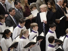 U.S. President Donald Trump, fourth back right, First Lady Melania Trump, third back right, Vice President Mike Pence, second back right, and Second Lady Karen Pence, back right, attend the National Prayer Service at the National Cathedral in Washington, D.C., on Saturday, Jan. 21, 2017.