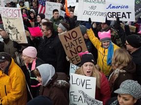 People chant and sing during a protest against an executive order on immigration from President Trump at Gerald R. Ford International Airport in Grand Rapids on Sunday, Jan. 29.