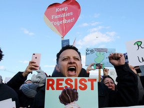 In this Jan. 29, 2017 photo, Jorge Torres takes part in a rally protesting President Donald Trump's executive order banning travel to the U.S. by citizens of Iraq, Syria, Iran, Sudan, Libya, Somalia or Yemen, in Elizabeth, N.J., outside the Homeland Security Detention Center.
