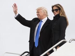 U.S. President-elect Donald Trump and his wife Melania arrive at Joint Base Andrews outside Washington, D.C., U.S., on Thursday, Jan. 19, 2017