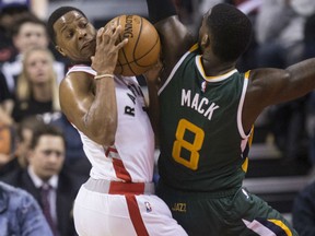 Toronto Raptors guard Kyle Lowry gets blocked by Utah Jazz guard Shelvin Mack in Toronto on Thursday.