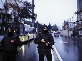 Turkish police officers block the road leading to the scene of an attack in Istanbul, early Sunday, Jan. 1, 2017.