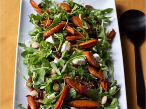Roasted carrots, cranberries and nuts combine with goat cheese and greens in this brightly coloured winter salad.