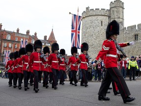 Soldiers from the Queen's Guard prepare for the Changing of the Guard ceremony at Windsor Castle, west of London.