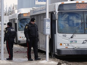 Police investigate at the scene of a fatal stabbing of a bus driver at the University of Manitoba in Winnipeg, Tuesday, February 14, 2017.