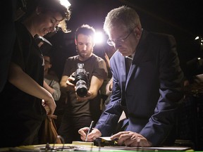 NDP MP Charlie Angus signs a book for a supporter after announcing his intention to run for the NDP Federal Leadership at a rally in Toronto , on Sunday February 26, 2016.