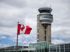 The Canadian flag flying near the control tower at Montreal's Pierre Elliott Trudeau International Airport on Wednesday, May 20, 2015.