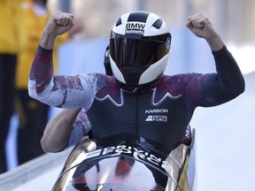 Canada's Justin Kripps, front, and Jesse Lumsden celebrate their run in the men's two-man race at the Bobsleigh World Championships at Lake Koenigssee, Germany, on Feb. 19.