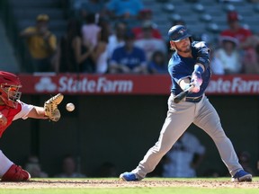 In this Sept. 18 file photo, then-Los Angeles Angels catcher Juan Graterol (left) — now a member of the Toronto Blue Jays — catches a strike behind Josh Donaldson.