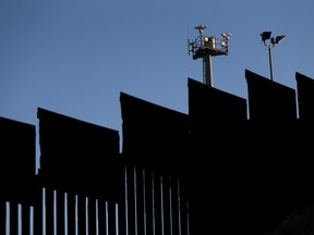 Surveillance cameras stand above the US-Mexican border fence at Playas de Tijuana on January 27, 2017 in Tijuana, Mexico