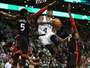 Isaiah Thomas of the Celtics takes a shot against Toronto Raptors' DeMarre Carroll and Lucas Nogueira during the fourth quarter at TD Garden in Boston on Wednesday night. The Celtics won 109-104.
