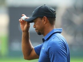 Tiger Woods of the United States acknowledges the crowd on the 9th green during the first round of the Omega Dubai Desert Classic at Emirates Golf Club on February 2, 2017 in Dubai, United Arab Emirates.