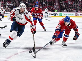 Jay Beagle of the Washington Capitals and the Canadiens' Nathan Beaulieu chase the puck during their game at the Bell Centre in Montreal on Saturday night.