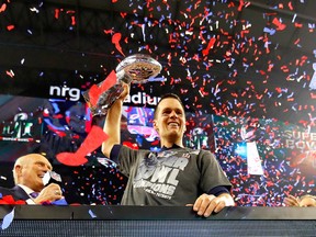 Tom Brady #12 of the New England Patriots celebreates with the Vince Lombardi Trophy after defeating the Atlanta Falcons during Super Bowl 51 at NRG Stadium on February 5, 2017 in Houston, Texas. The Patriots defeated the Falcons 34-28.