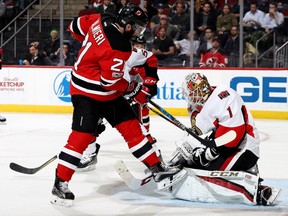 Ottawa Senator goaltender Mike Condon stops a shot from Kyle Palmieri of the Devils in the second period of their game on Thursday night at the Prudential Center in Newark, N.J.