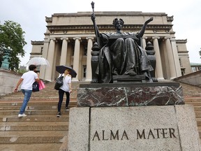 People walk past the Alma Mater statue on the Columbia University campus on July 1, 2013 in New York City. The school sent then retracted acceptance offers to 277 students this week.