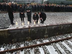 Israeli soldiers stand at attention as officials light candles at Track 17 at Grunewald train station on November 21, 2008 in Berlin to honour the thousands of Berlin Jews deported from Track 17 to concentration camps, mainly Theresienstadt and Auschwitz, between 1941 and 1944.