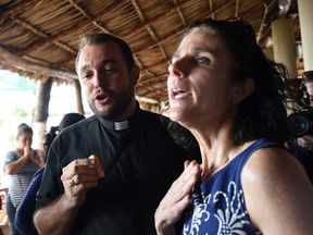 Rebecca Gomperts, founder of the Dutch organization Women on Waves, speaks with seminarian Gil Hernandez after a press conference at the Pez Vela Marina in the port of San Jose, 120 km south of Guatemala City, on February 23, 2017.