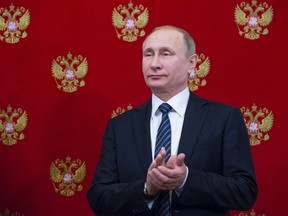 Russian President Vladimir Putin applauds during a signing ceremony following his talks with Slovenian President at the Kremlin in Moscow on Feb. 10.